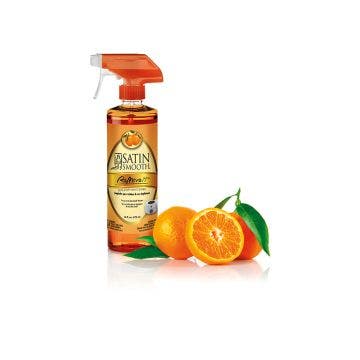Display of a post-waxing treatment spray cleaner with ripe sliced tangerine citrus with leaf on the side